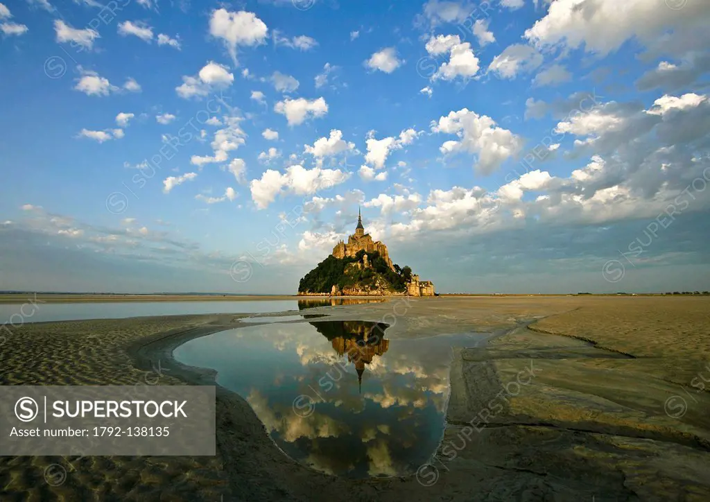 France, Manche, Bay of Mont Saint Michel, listed as World Heritage by UNESCO, Mont Saint Michel reflections in the light of the sunset