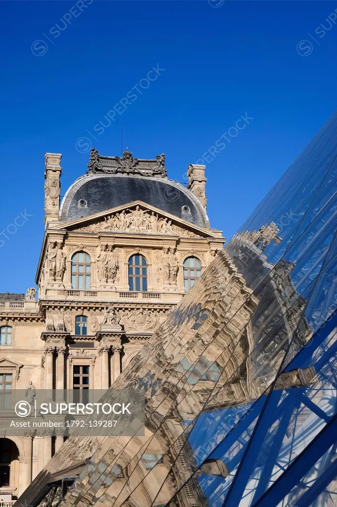 France, Paris, reflection of the facade of the Richelieu Wing on the pyramid of the Louvre by the architect Ieoh Ming Pei in the Cour Napoleon