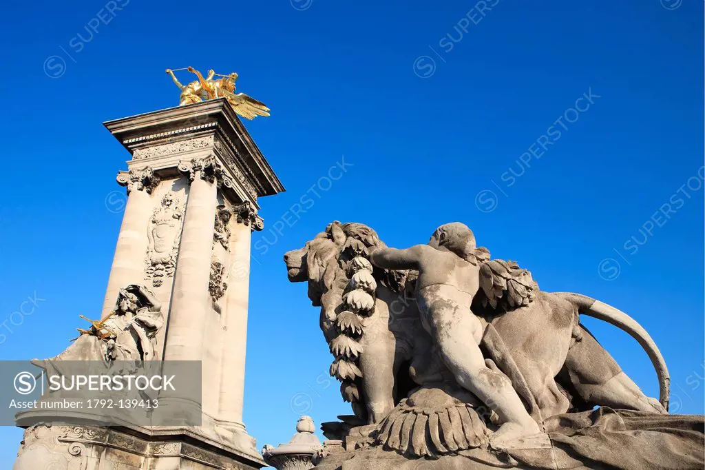 France, Paris, pont Alexandre III, statue by Jules Dalou Lion conduit par un enfant at the feet of one of the column headed by a statue of the Renomme...