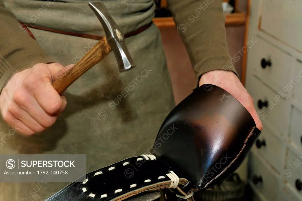 France, Haut Rhin, Muhlbach, harness maker Jean Claude Mann, manufacturing collar cowbell, the seam of the cowbell is flattened with a hammer,