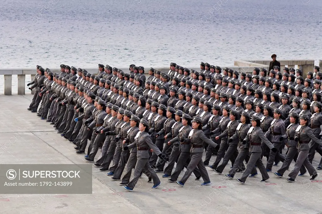North Korea, Pyongyang, Juche tower esplanade, squad of female teenagers in military uniforms rehearsing for a parade