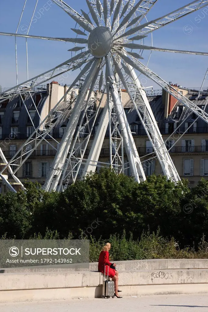 France, Paris, woman in the Tuileries Gardens and the Great Wheel