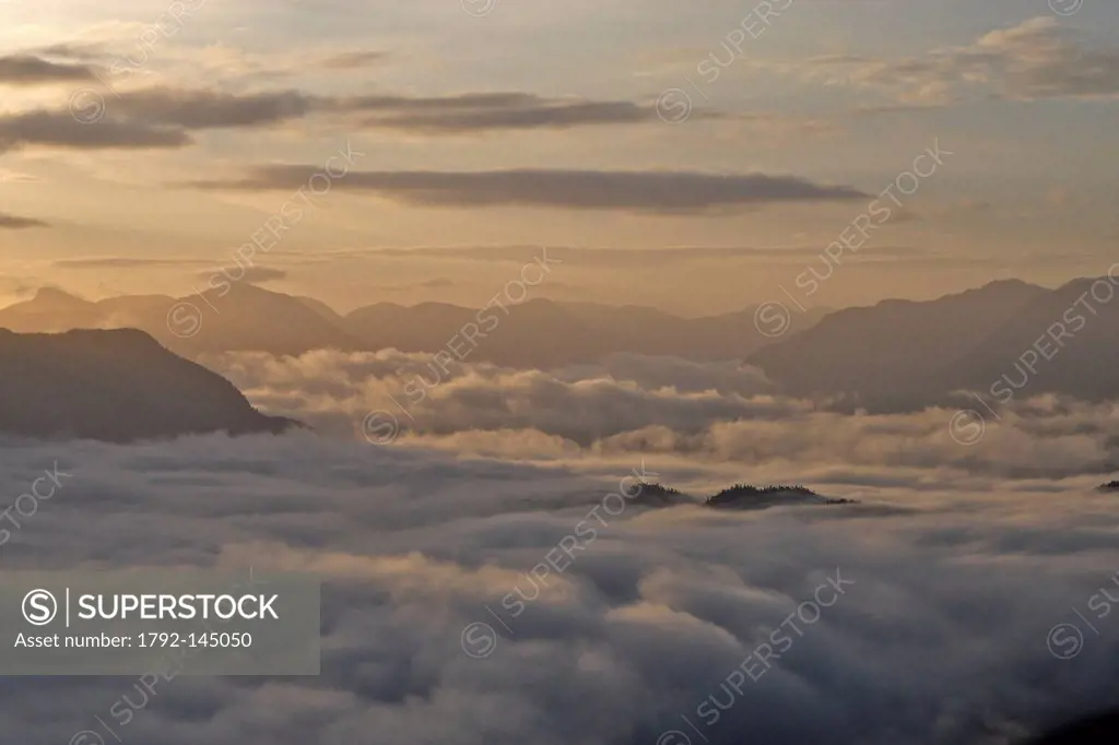 Canada, British Columbia, North Western Coast of Vancouver Island, island in front of Telegraph Cove at the middle of a sea cloud aerial view