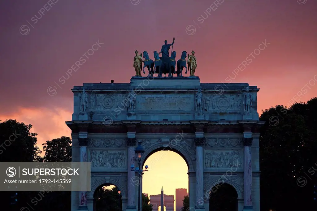 France, Paris, sunset over the arc de Triomphe du Carrousel du Louvre, the Obelisque de la Concorde and the Grande Arche de la Defense