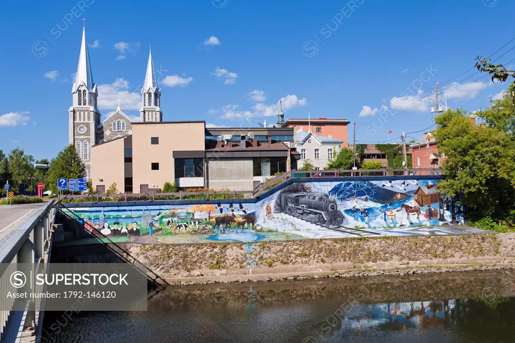 Canada, Quebec province, Charlevoix region, St Lawrence river raod, Baie St Paul, the church and the mural depicting the history of the region and its...