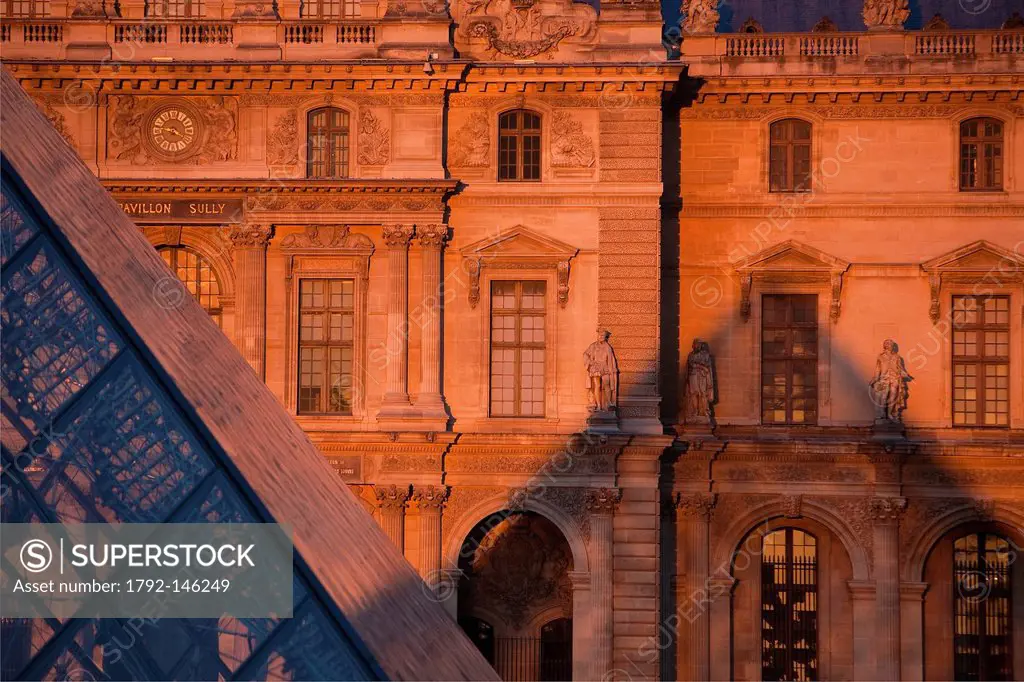 France, Paris, the Pyramide du Louvre by the architect Ieoh Ming Pei and the facade of the Cour Napoleon