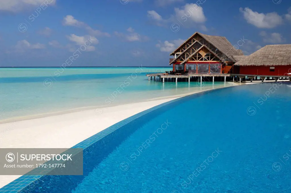 Maldives, South Male Atoll, Dhigu Island, Anantara Resort and Spa Hotel, swimming pool and white sand beach overlooked by a restaurant on stilts in th...