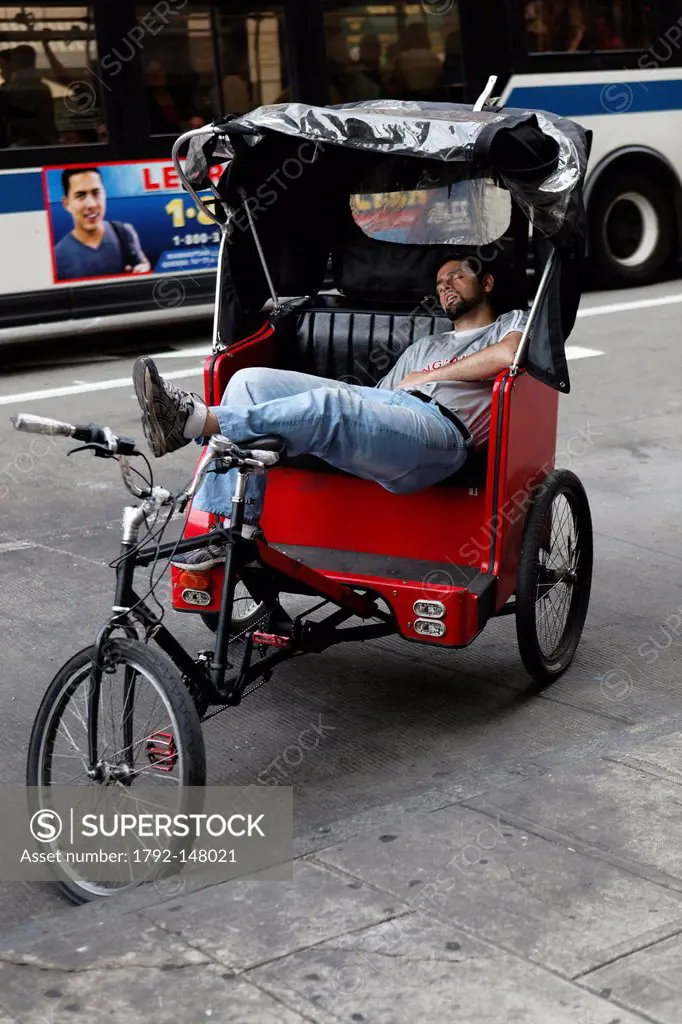 United States, New York City, Manhattan, driver of pedicab having a nap