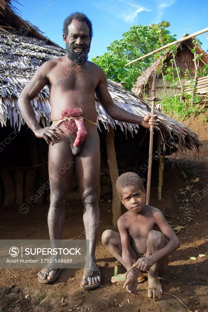 Vanuatu, Penama Province, Pentecost Island, Bunlap, portrait of a father and his son in traditional clothing, in front of their house