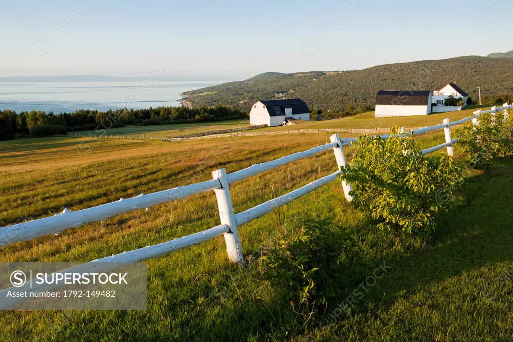 Canada, Quebec province, Charlevoix region, St Lawrence river raod, St Irenee and its magnificent view, wooden fence painted white, and traditional fa...