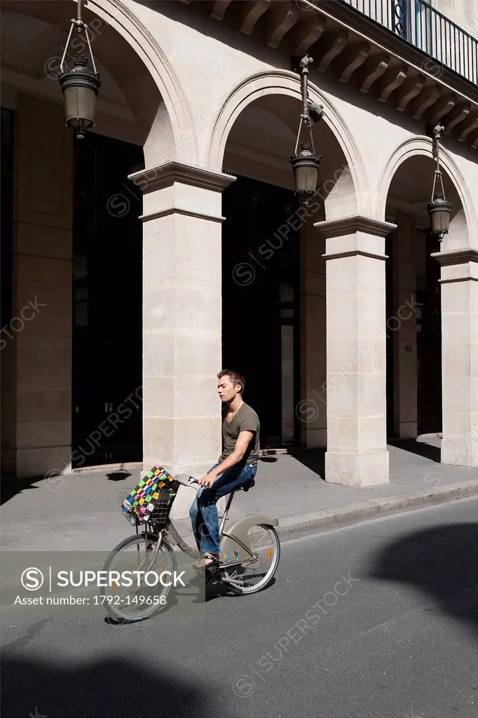 France, Paris, man riding a Velib on Rivoli street