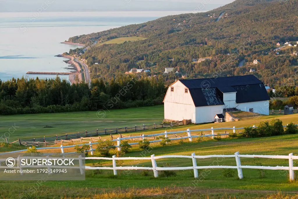Canada, Quebec province, Charlevoix region, St Lawrence river raod, St Irenee and its magnificent view, field and traditional farm