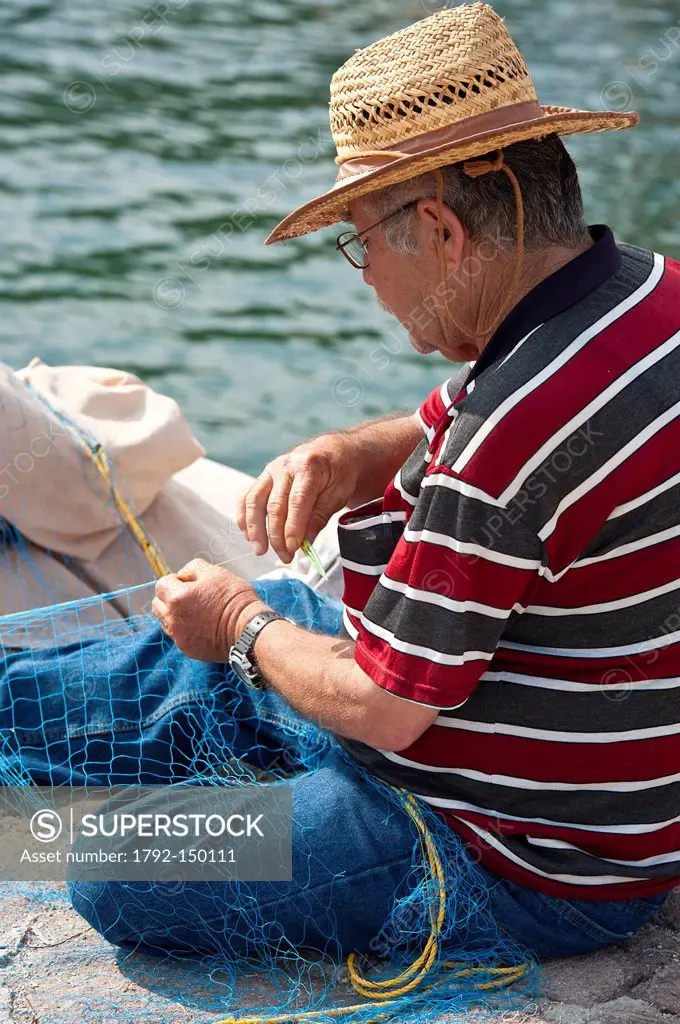 Grce, north east Aegean islands, Lesbos island, Skala Sikaminia, the harbour on the north coast, mending nets