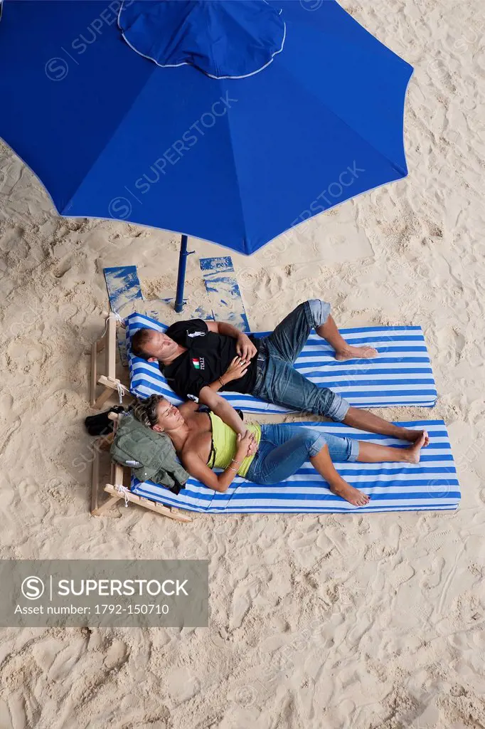 France, Paris, Paris plage, couple sunbathing on a sand beach