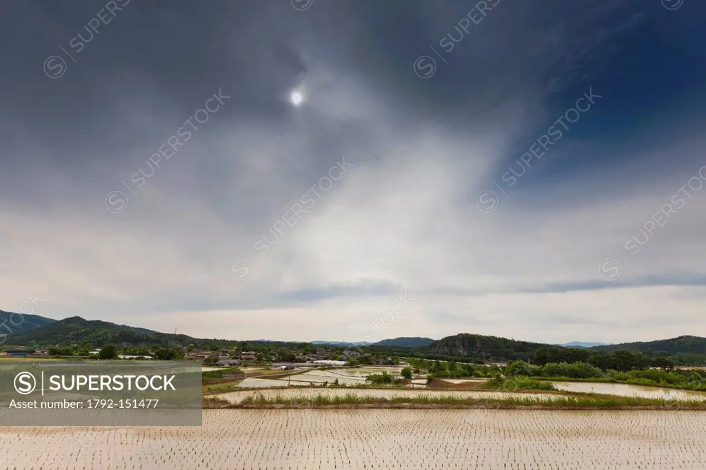 South Korea, North Gyeongsan Province, Andong, Hahoe Traditional Village, flooded rice paddies and stormy sky