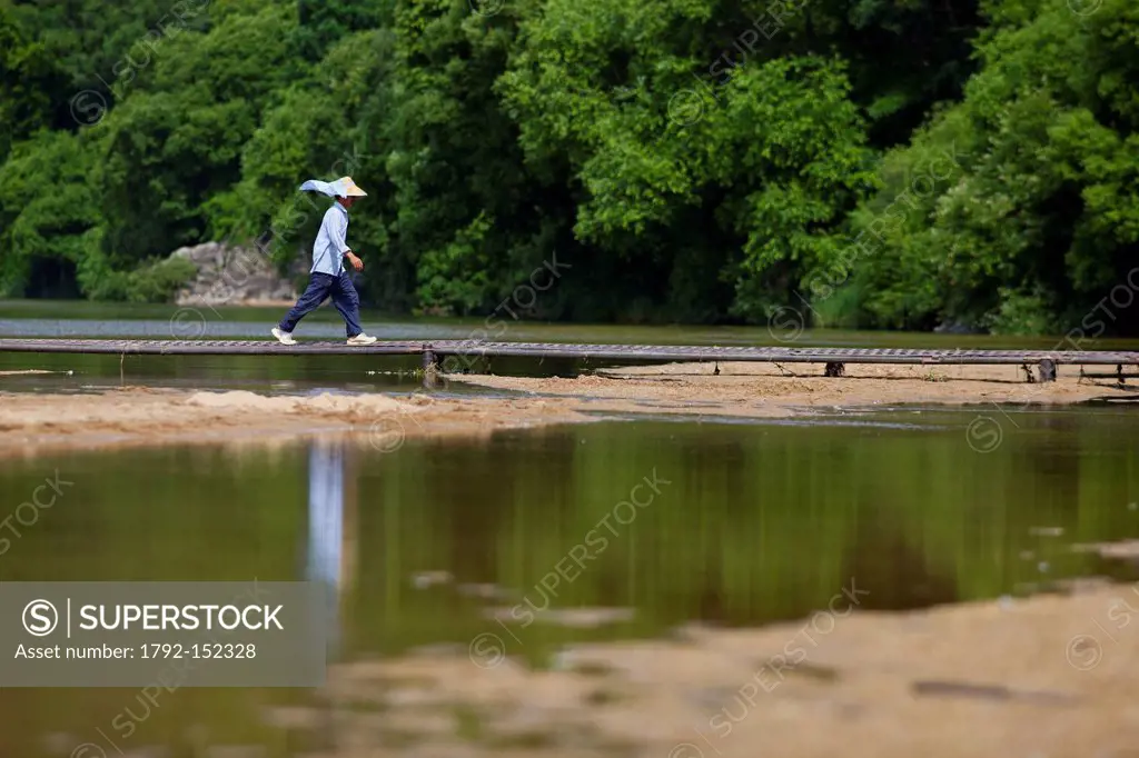 South Korea, North Gyeongsan Province, Mungyeong, Hoeryongpo, farmer walking across a river