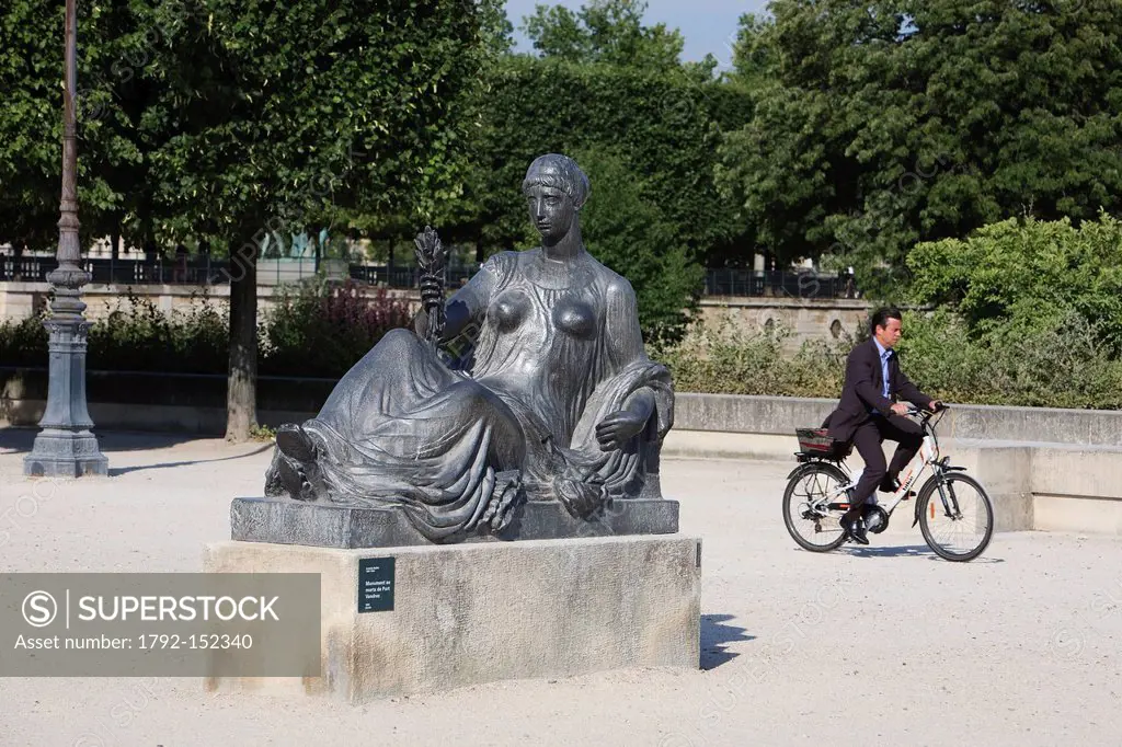 France, Paris, sculpture by Aristide Maillol Monument aux Morts de Port Vendres in the Tuileries Gardens and man riding a bicycle