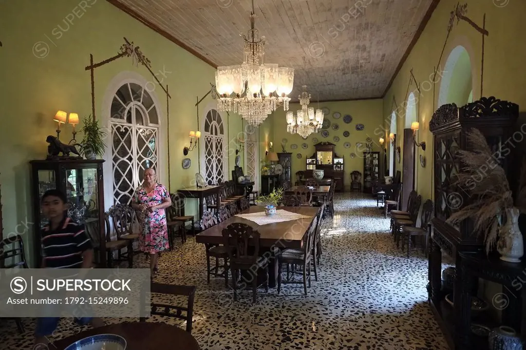 India, Goa state, South Goa, Menezes Braganza House in Chandor, in the photo Mrs Judith Borges in the living room called sala in Portuguese, filled wi...