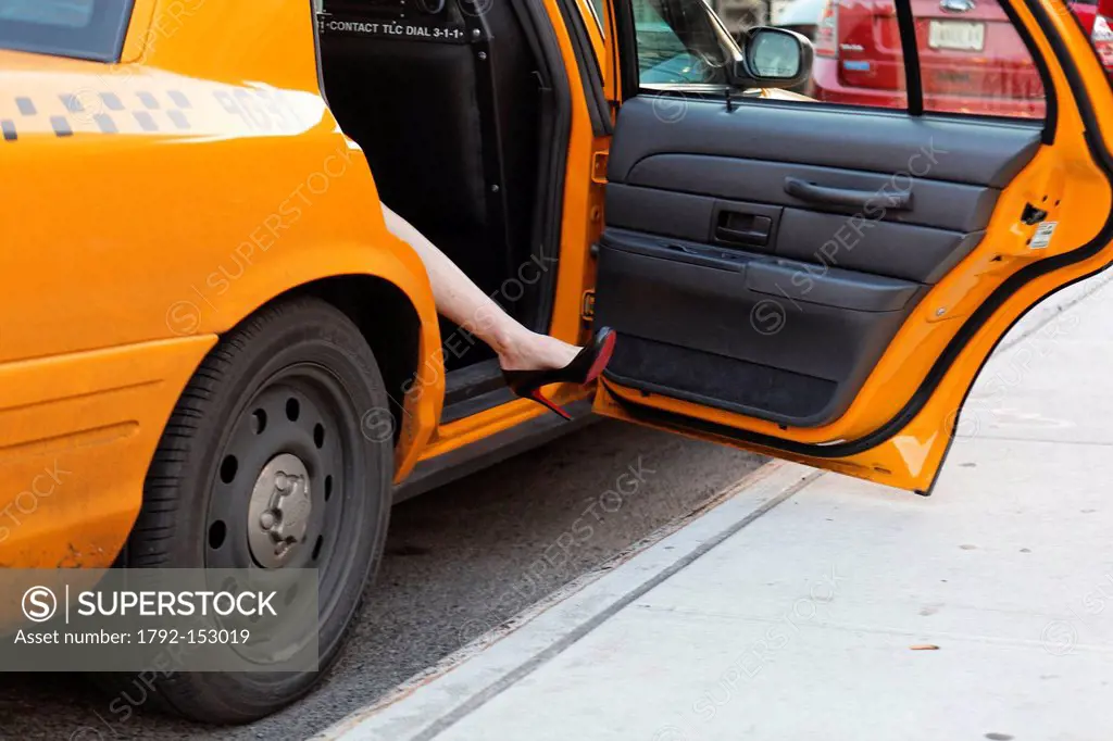 United States, New York City, Manhattan, Midtown, leg of a woman going out of a taxi