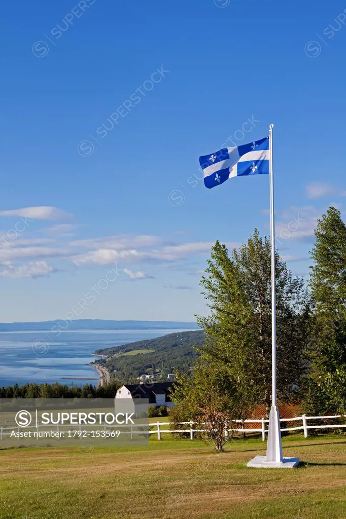 Canada, Quebec province, Charlevoix region, St Lawrence river raod, St Irenee and its magnificent view, traditional farm and Quebec flag