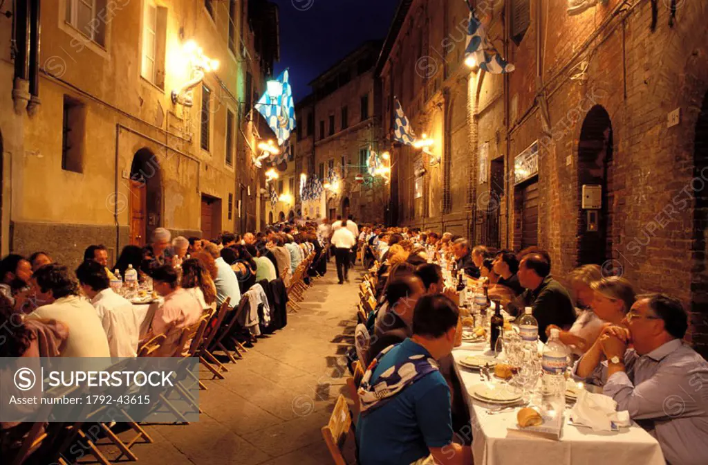 Italy, Tuscany, Siena, the large whole table the night before the Palio celebration