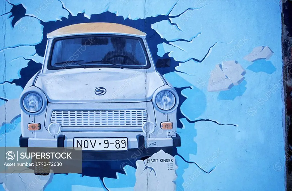 Germany, Berlin, the Wall, East Side Gallery, by the artist Birgit Kinder showing a Trabant car arriving in East Berlin entitled Test the best