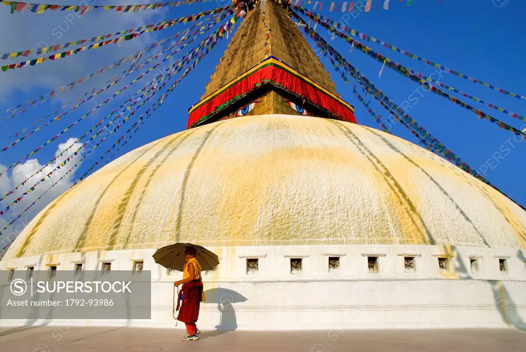 Nepal, Kathmandu Valley listed as World Heritage by UNESCO, Kathmandu, Bouddhanath Stupa, Tibetan pilgrim with umbrella, monk