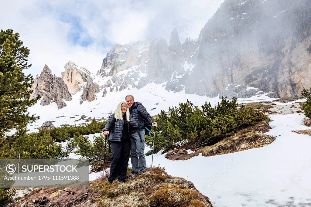 Couple hiking on Giau Pass in Dolomites, Italy