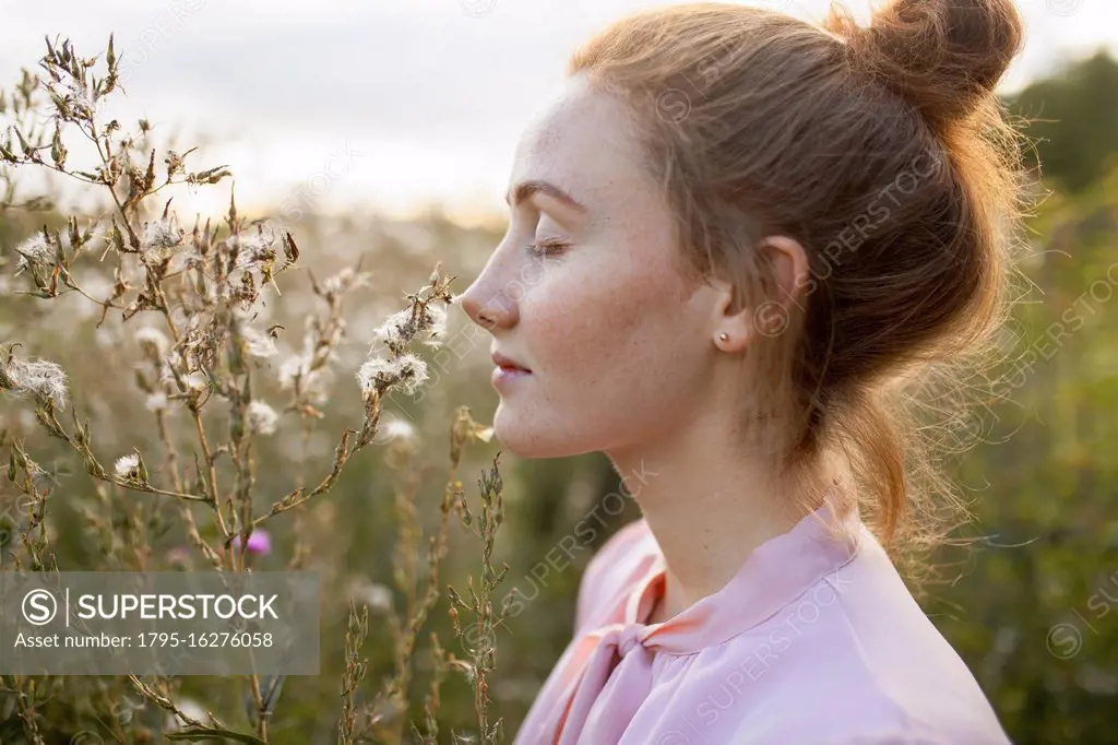 Russia, Omsk, Young woman in meadow