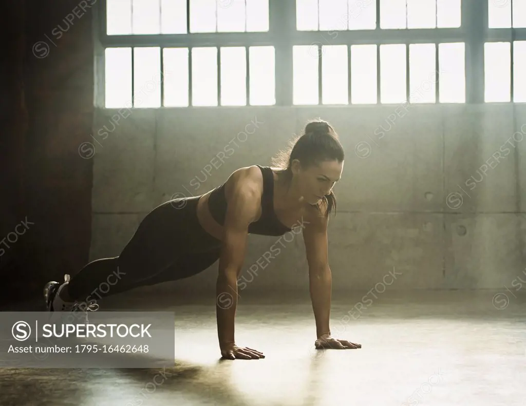Woman exercising in warehouse
