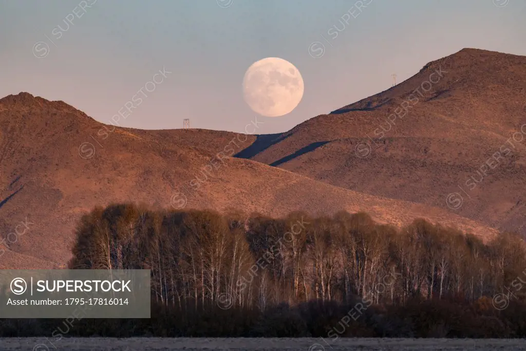 USA, Idaho, Bellevue, Full moon rising over mountains at dusk
