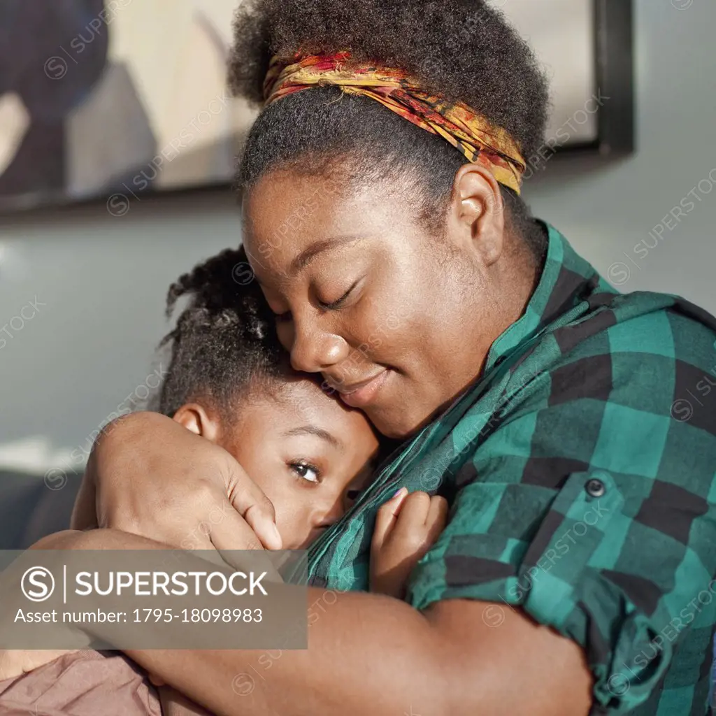 African American mother comforting daughter
