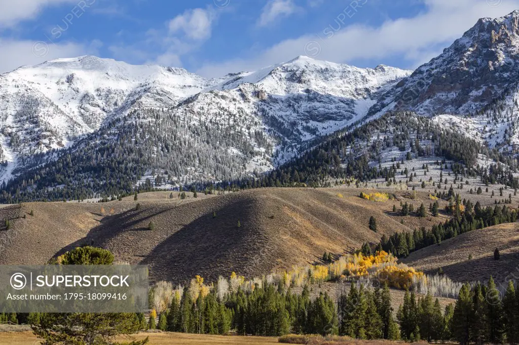 United States, Idaho, Sun Valley, Landscape with snowcapped Rocky Mountains and autumn forests in valleys