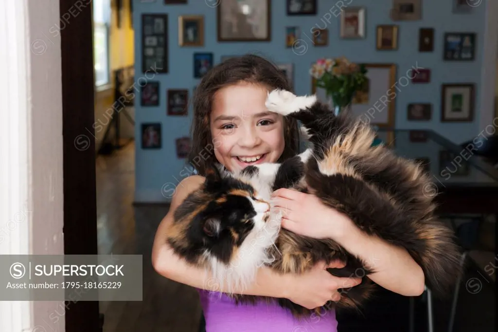 Girl holding pet cat