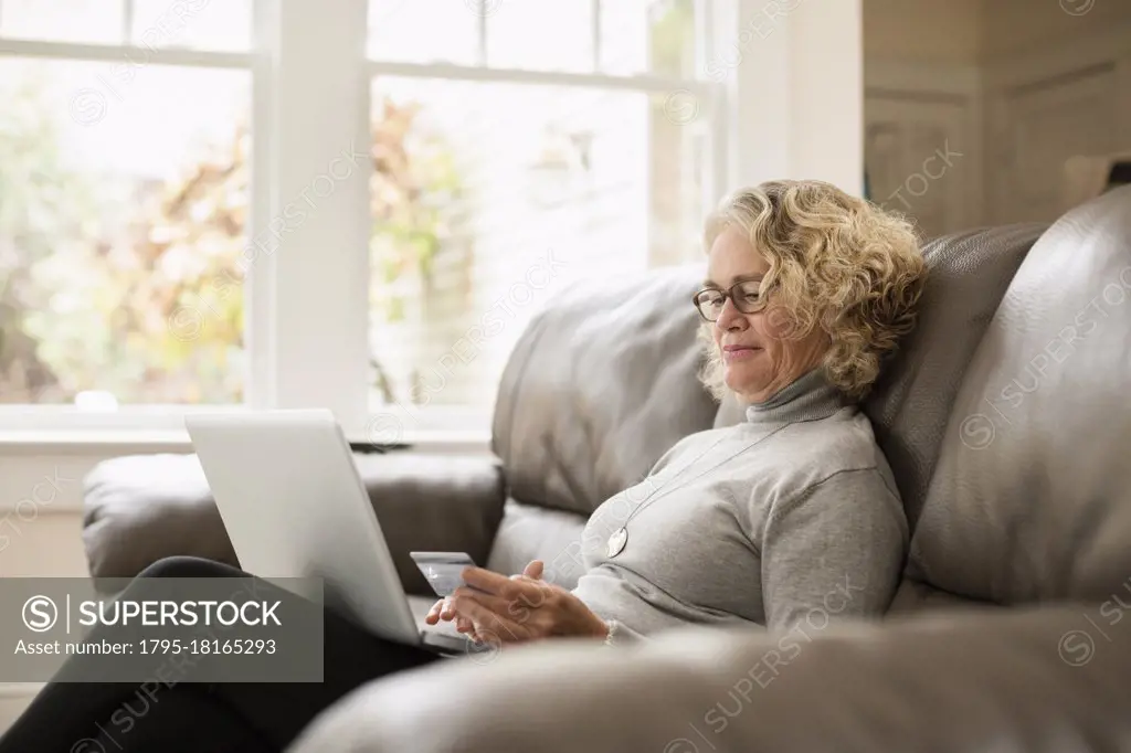 Senior woman shopping online on laptop