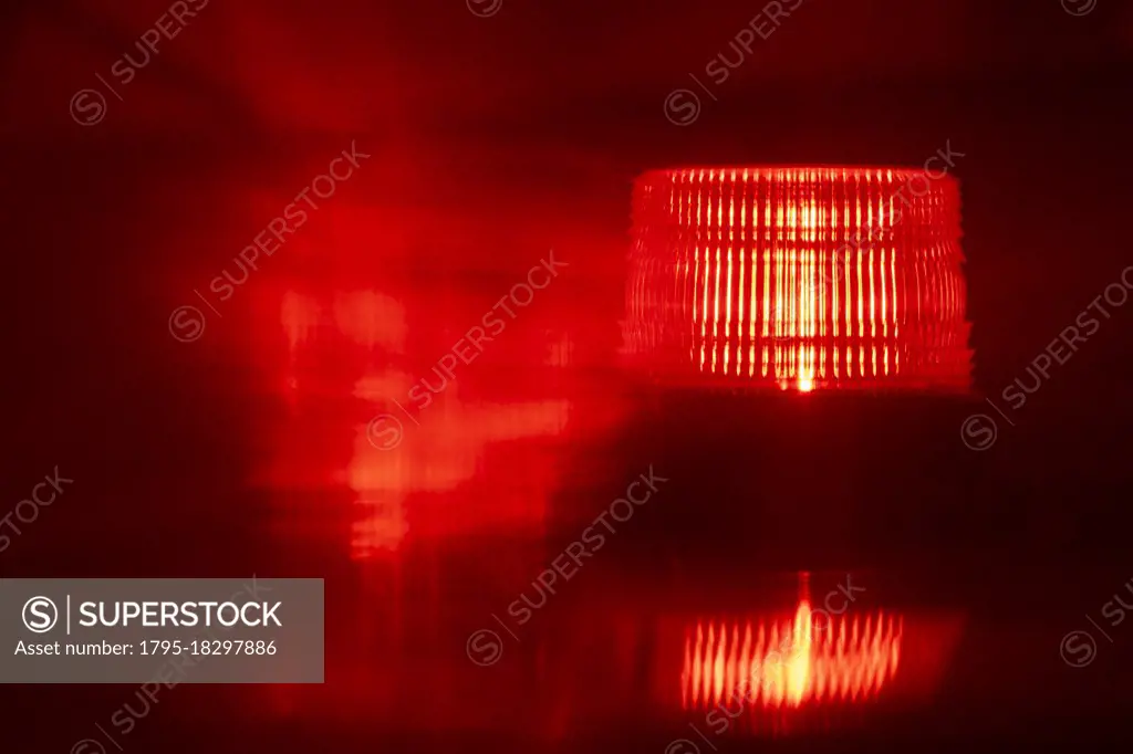 Close-up of flashing red emergency light at night