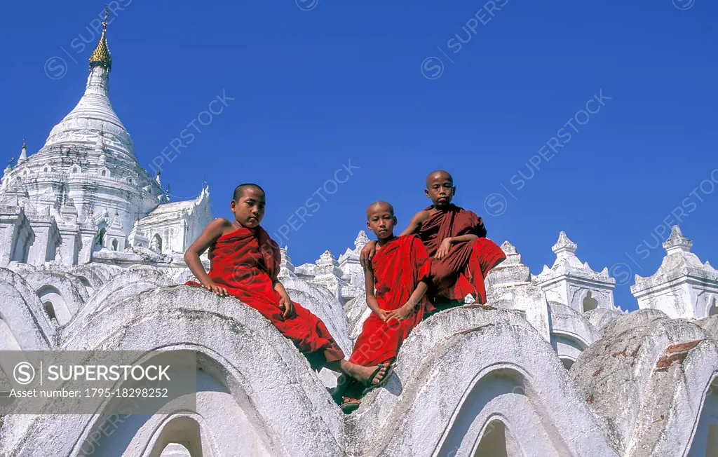 Myanmar, Mingun, Mandalay Division, Buddhist monks sitting on white arches of Hsinbyume Pagoda