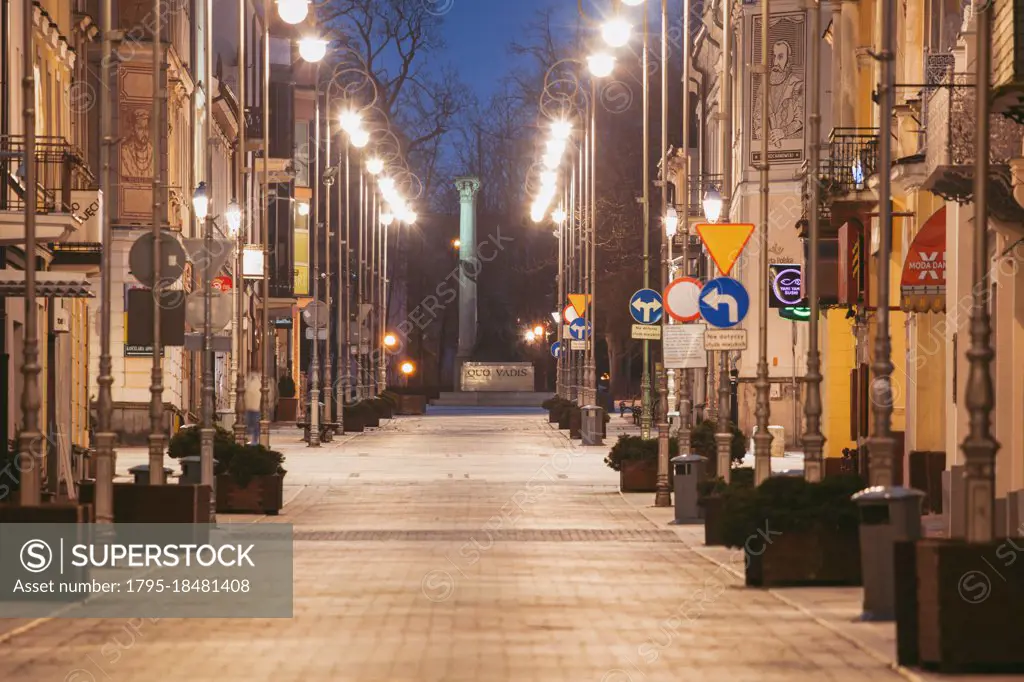 Poland, Holy Cross, Kielce, City street illuminated at night