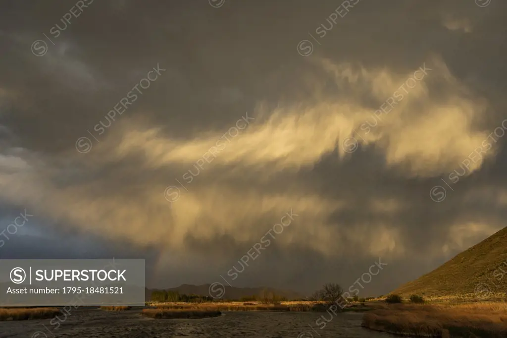 Usa, Idaho, Picabo, Storm clouds over landscape at sunset