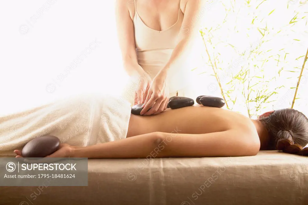 Woman receiving stone massage