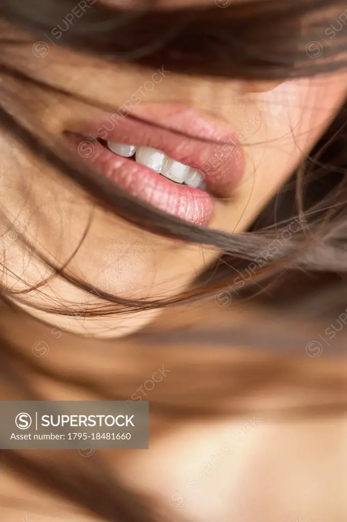 Close-up of woman's lips and brown hair