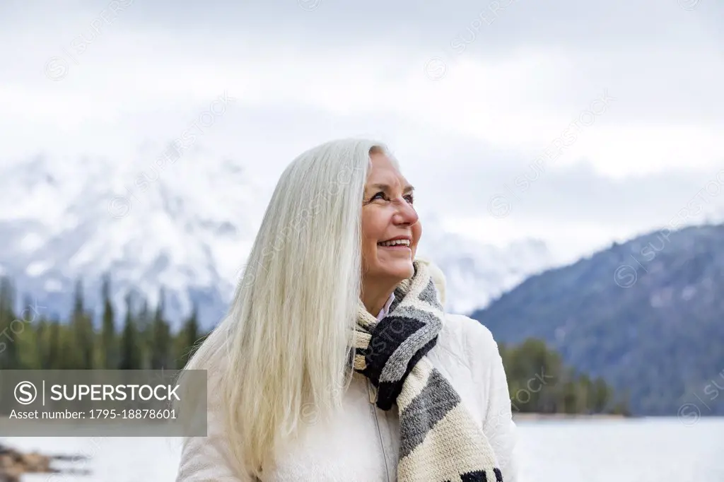 USA, Idaho, Stanley, Smiling senior woman at mountain lake
