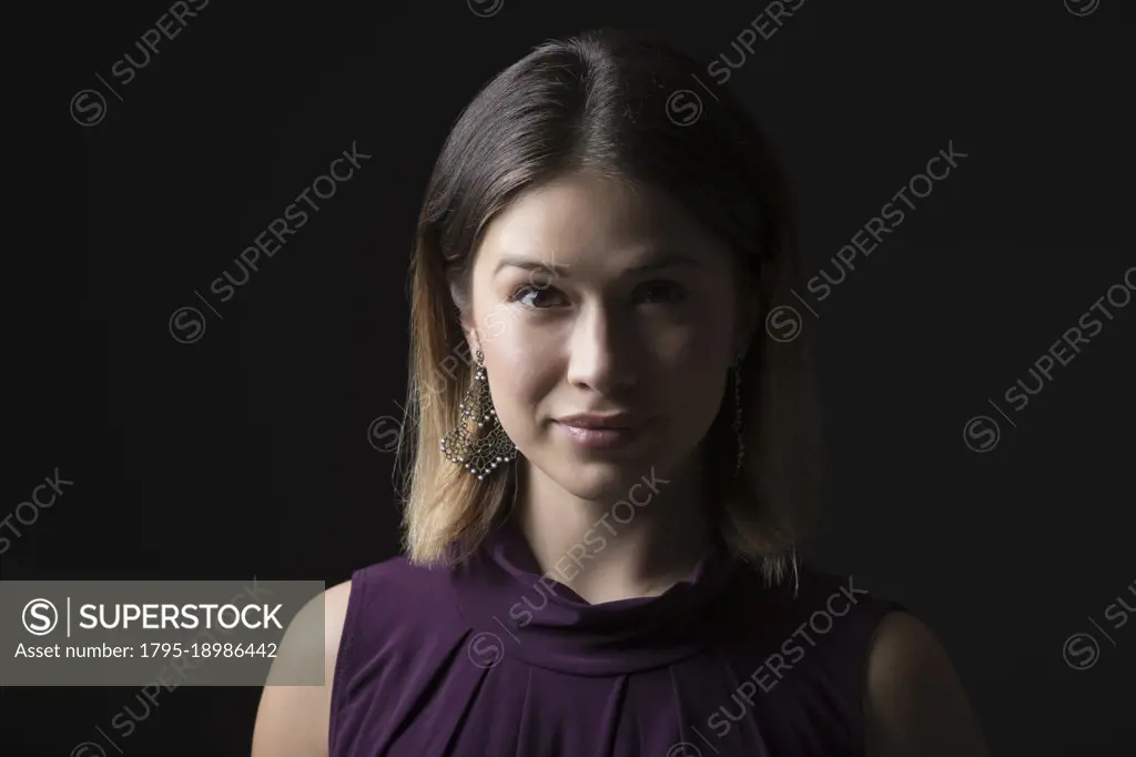 Studio portrait of woman in sleeveless purple top