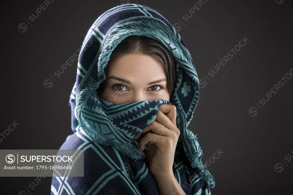 Studio portrait of woman with shawl on head