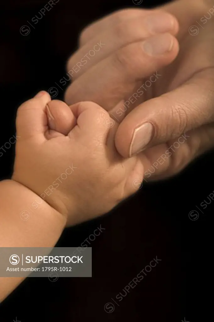 Hands of a father and his baby