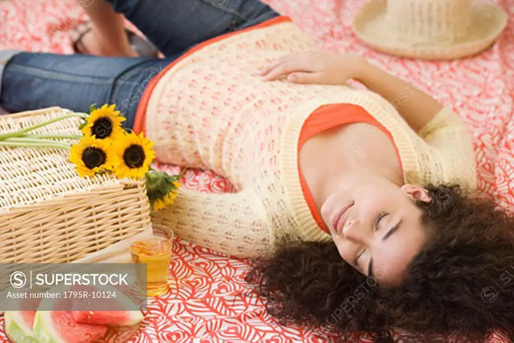 Woman laying on picnic blanket