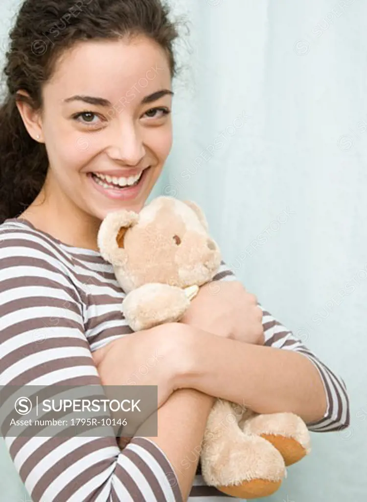 Woman hugging teddy bear