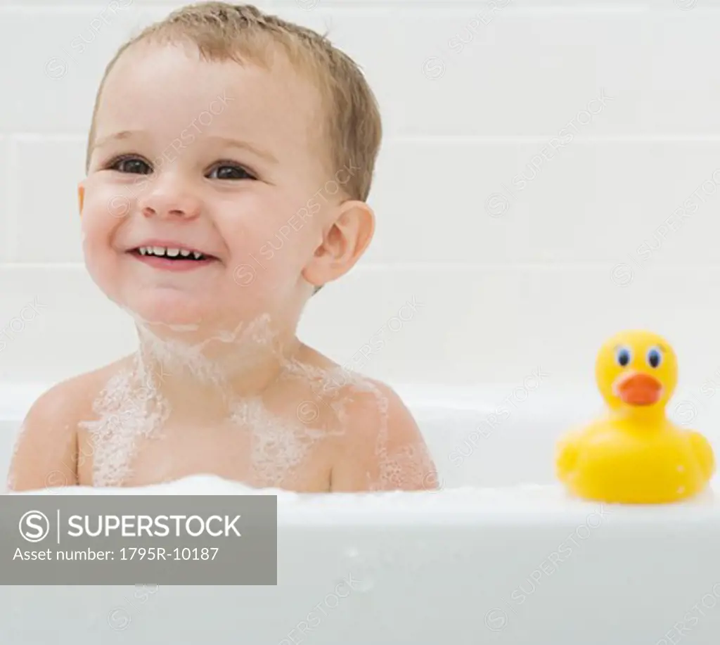 Baby and rubber duck in bath