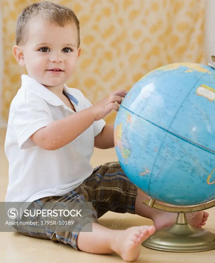 Baby touching globe