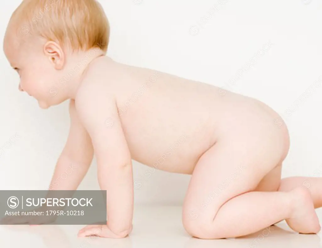 Nude baby crawling